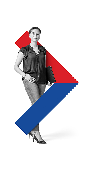 Short haired women standing in jeans and heels holding laptop