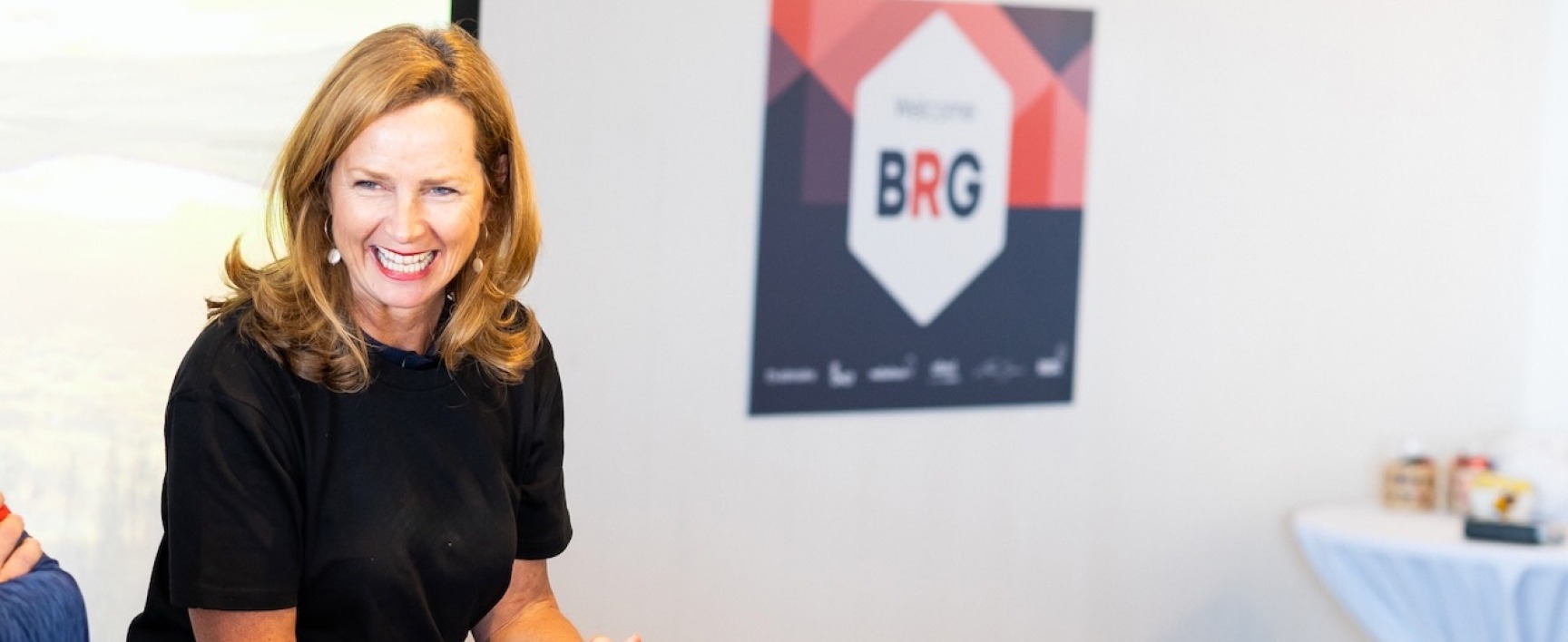 Naomi Simson leading a session at BRG event with a table of refreshments in the background.