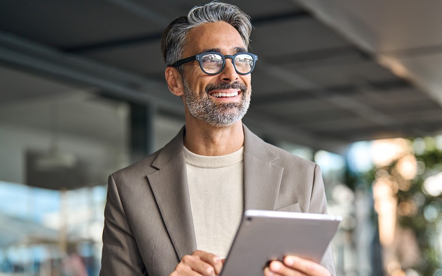 Person using a tablet in an outdoor business environment.
